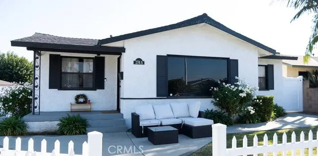 a front view of house with yard outdoor seating and barbeque oven