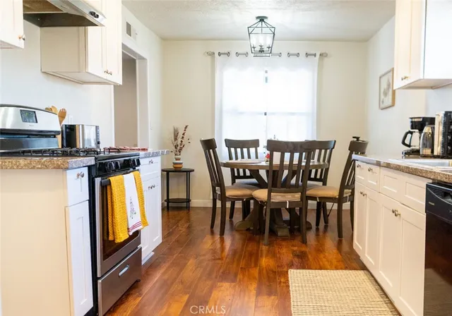 a view of a dining room with furniture and wooden floor