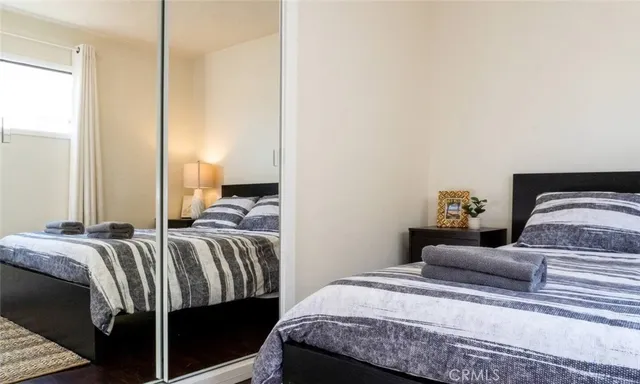 a bed room with a bed and a balcony