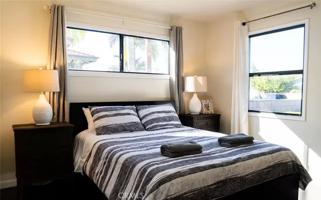 a bedroom with a large bed and a window