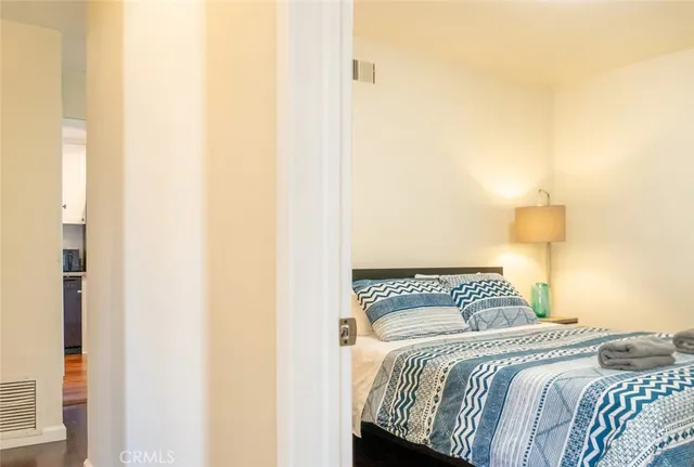 a bedroom with a bed and a night stand