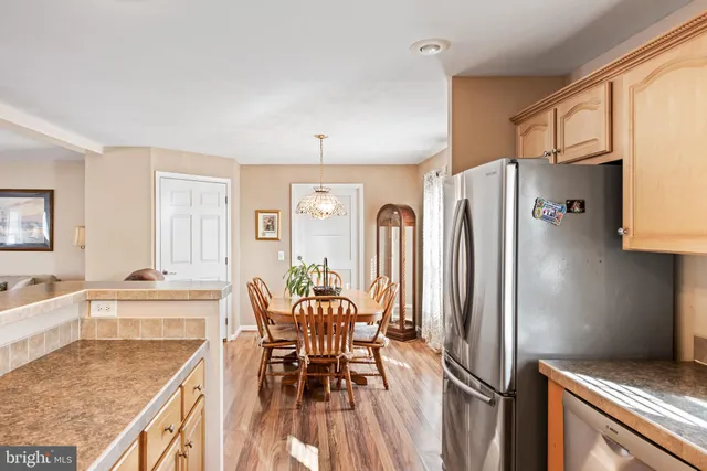 a kitchen with stainless steel appliances granite countertop a refrigerator and a stove