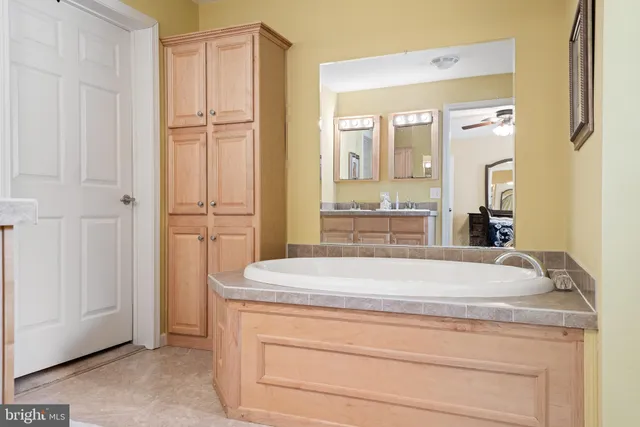 a bathroom with a granite countertop sink and mirror