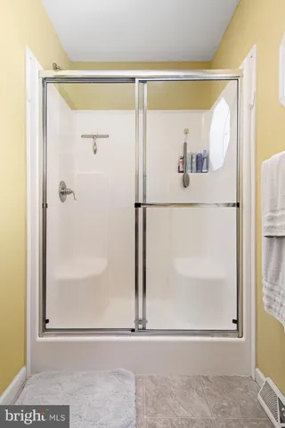 a view of a small space with wooden floor and a door