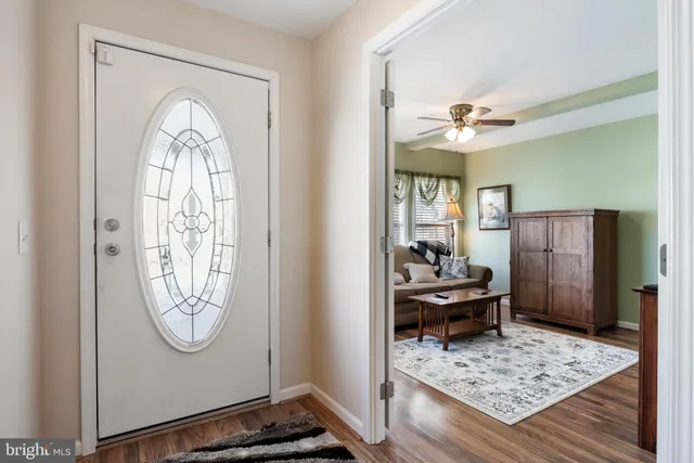 a view of hall way with furniture and a chandelier