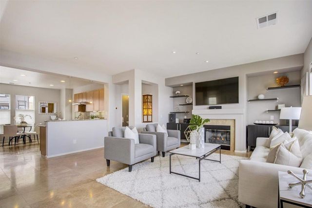 a dining room with furniture a chandelier and window