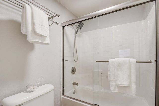 a bathroom with a sink mirror vanity and toilet