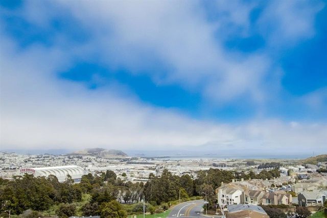 a view of a hallway with a white walls and stairs