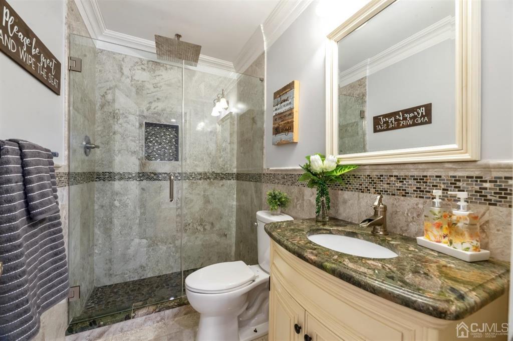 47 Agate Road East Brunswick, NJ 08816 - Photo 15 of 47 a bathroom with a granite countertop sink a toilet and a mirror