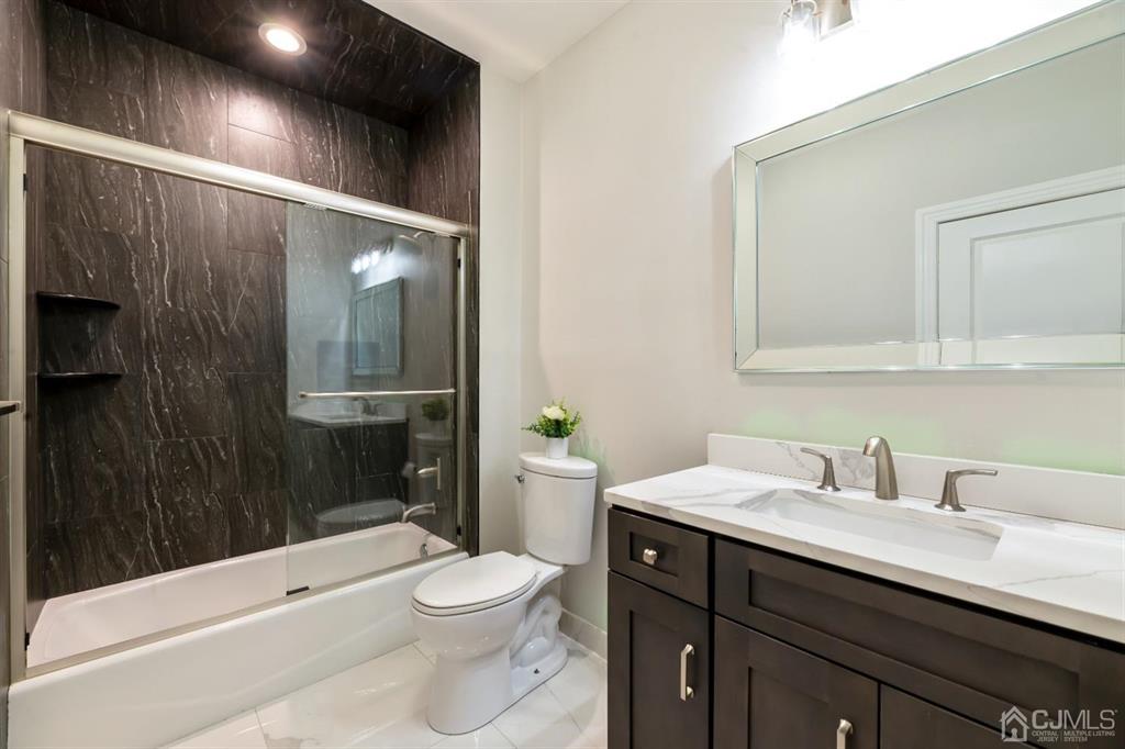 47 Agate Road East Brunswick, NJ 08816 - Photo 22 of 47 a bathroom with a sink a toilet a mirror and shower
