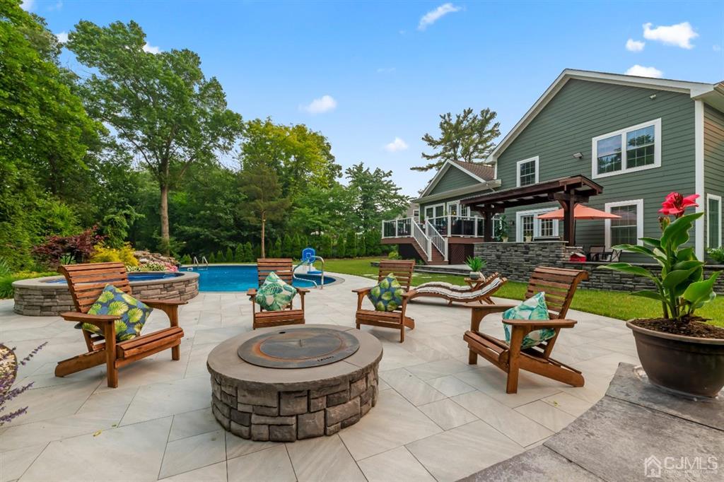 47 Agate Road East Brunswick, NJ 08816 - Photo 35 of 47 a backyard of a house with fire pit and outdoor seating
