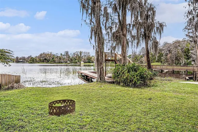 an aerial view of lake and residential houses with outdoor space