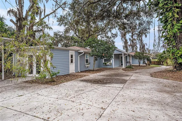 a view of a house with a yard and pathway