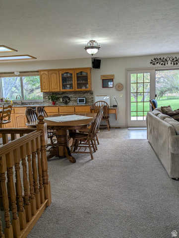 1040 West Mill Road Ferron, UT 84523 - Photo 24 of 117 Kitchen featuring wood-finish cabinetry, stone-look countertops, and an undermount sink