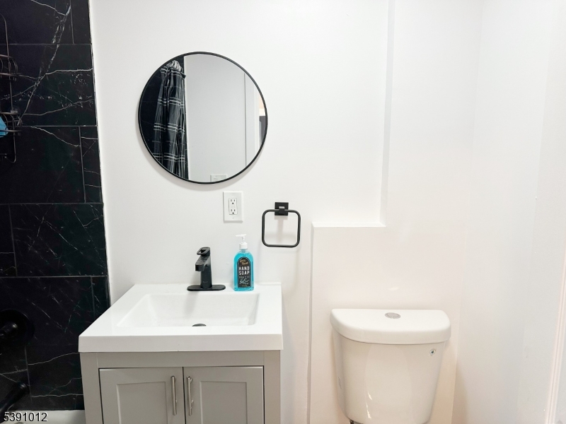 26 Duryea Street Newark, NJ 07103 - Photo 2 of 15 a bathroom with a sink and a mirror