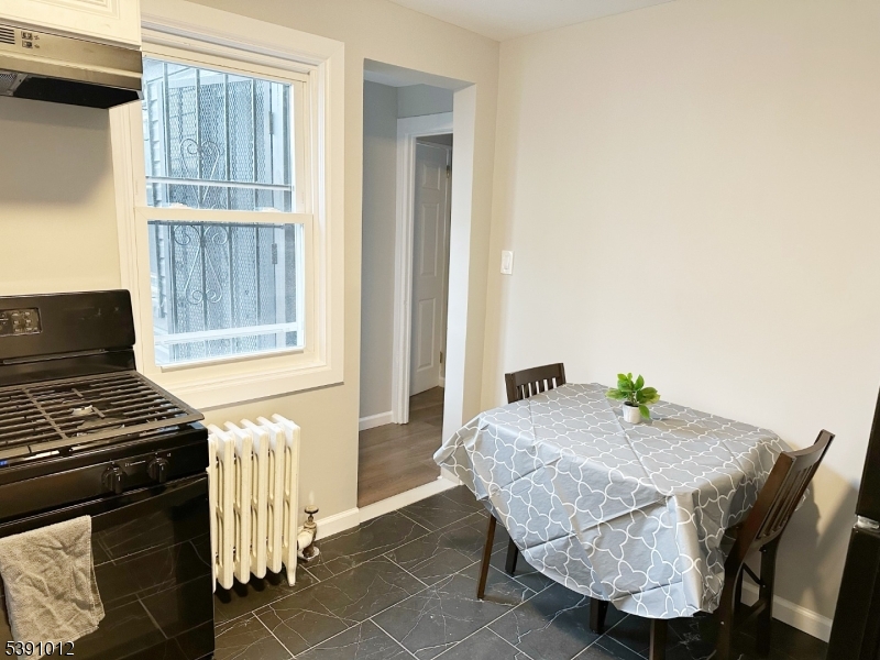 26 Duryea Street Newark, NJ 07103 - Photo 8 of 15 a dining room with furniture and a window