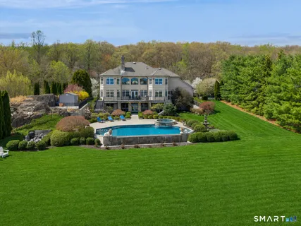 a aerial view of a house with swimming pool garden and mountain view