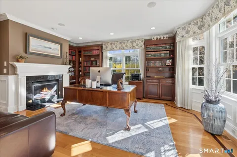 a living room with furniture large window and a fireplace