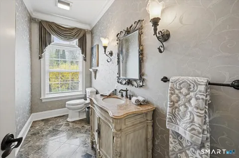 a bathroom with a sink toilet and a mirror
