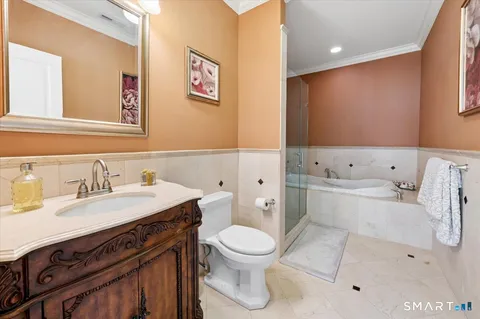 a bathroom with a sink a toilet and a mirror