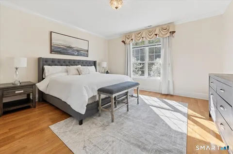 a bed sitting in a bedroom next to a window
