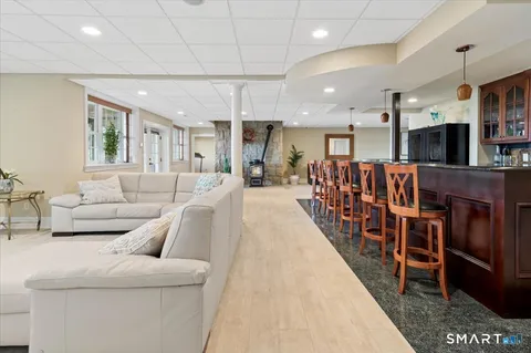 a living room with furniture a ceiling fan and a rug