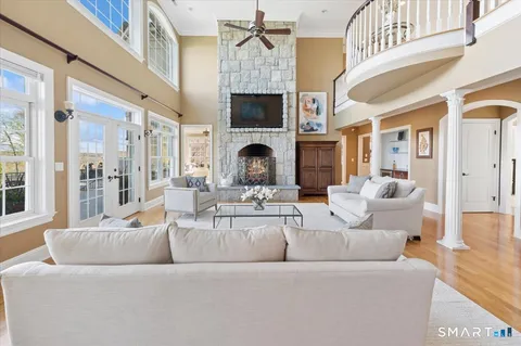 a living room with furniture a fireplace and a flat screen tv