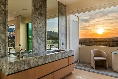 a bathroom with a granite countertop sink and a large mirror