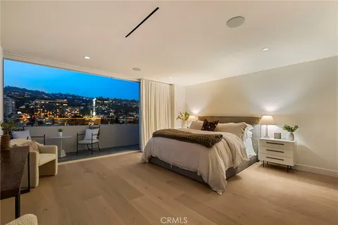 a balcony with outdoor seating and city view