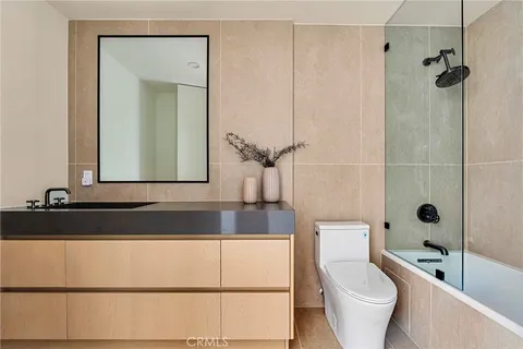 a bathroom with a mirror and a shower