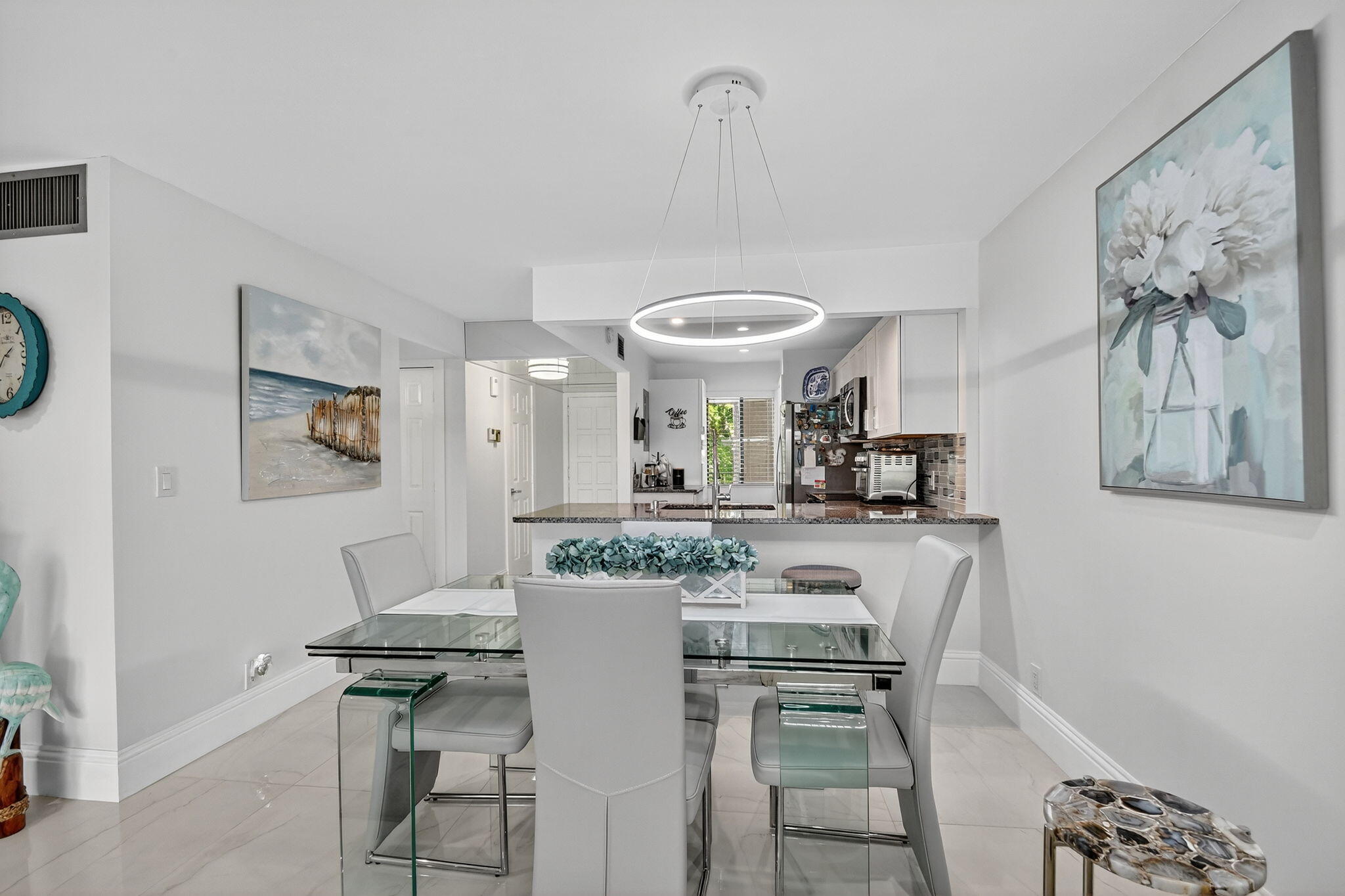4381 Trevi Court, Unit 303 Lake Worth, FL 33467 - Photo 11 of 80 a view of a dining room with furniture and a chandelier