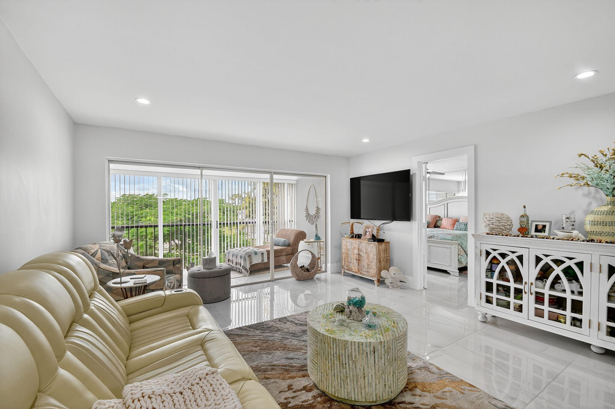 4381 Trevi Court, Unit 303 Lake Worth, FL 33467 - Photo 12 of 80 a living room with furniture and a flat screen tv