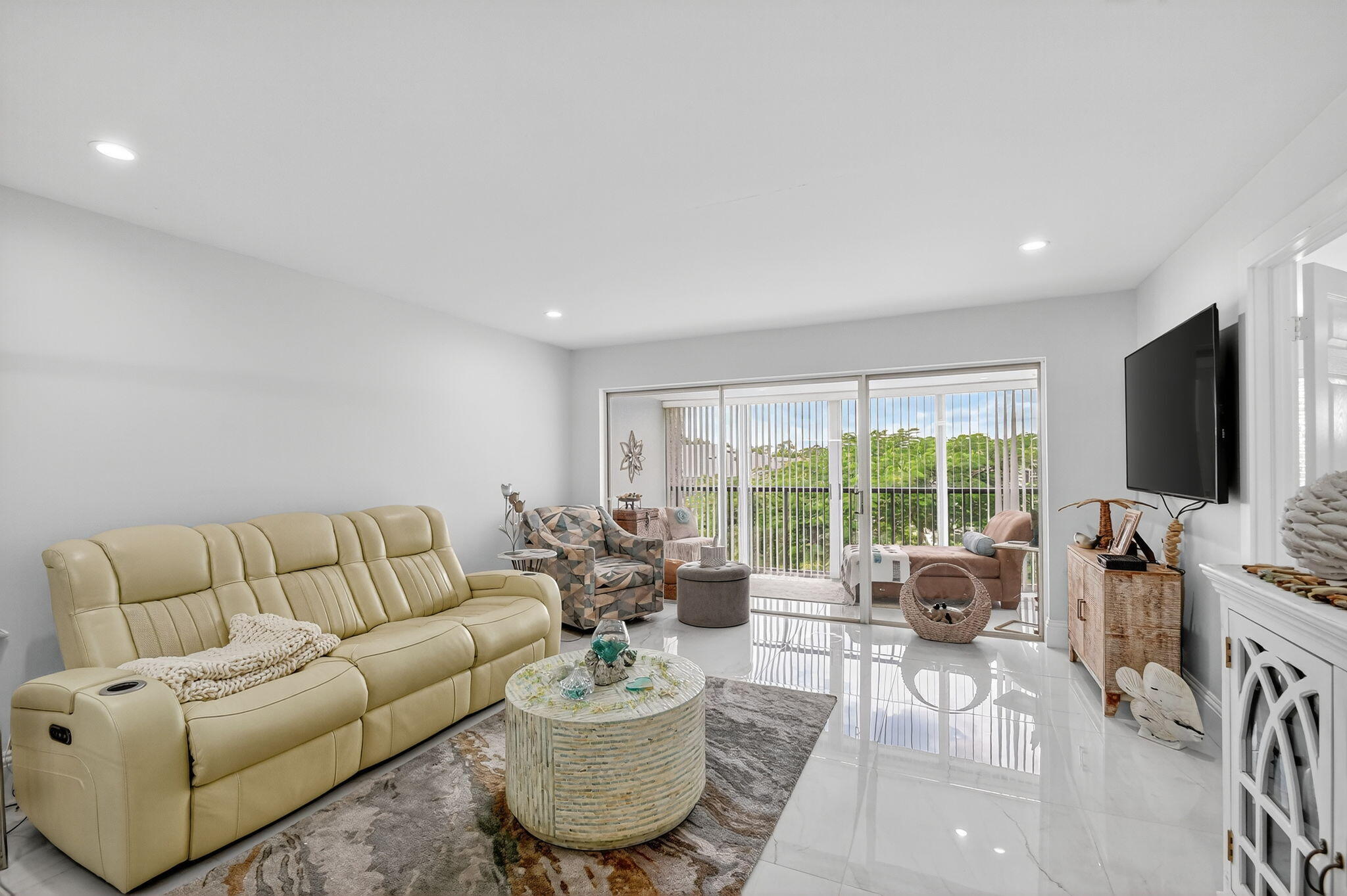 4381 Trevi Court, Unit 303 Lake Worth, FL 33467 - Photo 13 of 80 a living room with furniture and a flat screen tv