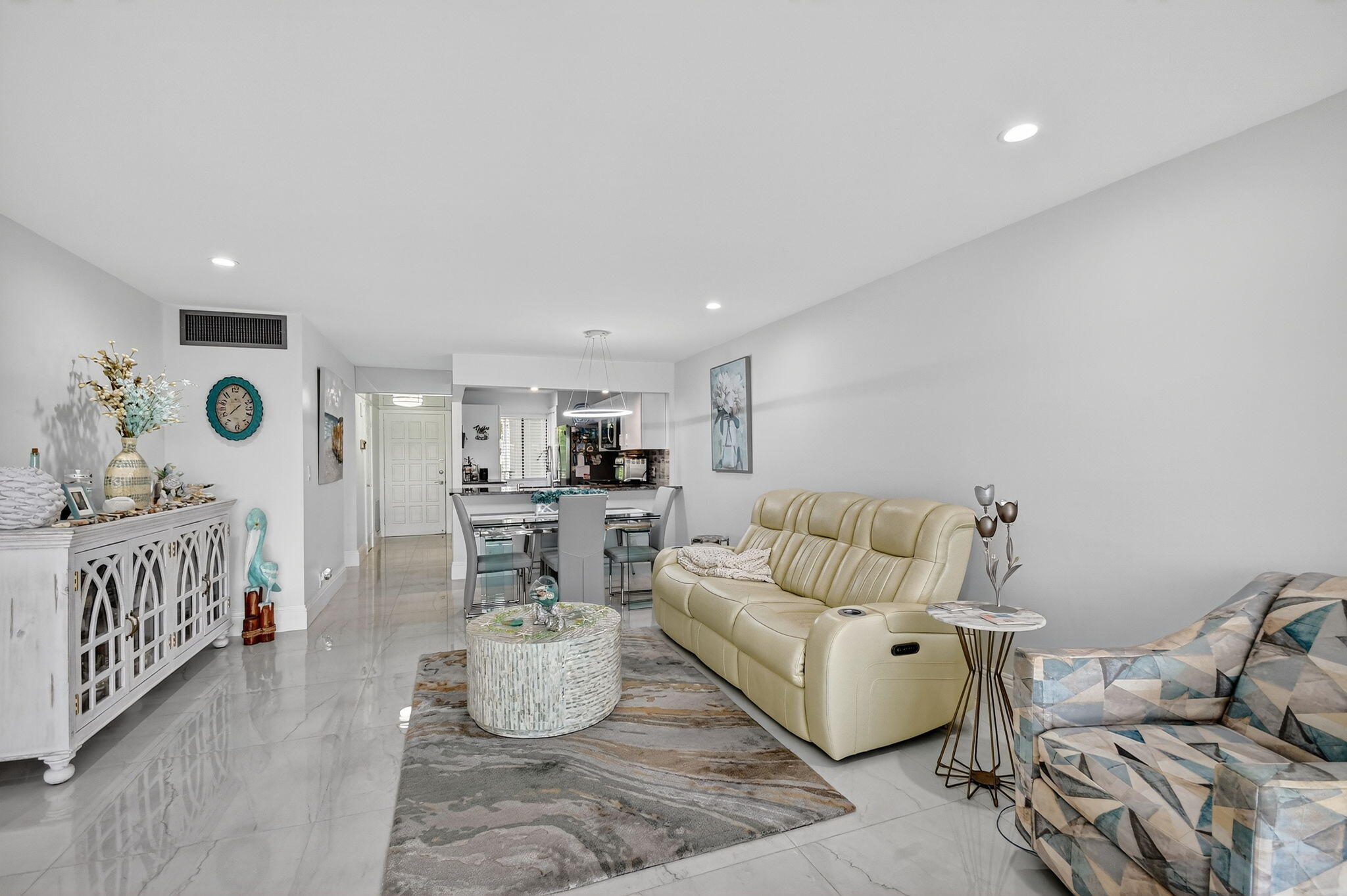 4381 Trevi Court, Unit 303 Lake Worth, FL 33467 - Photo 16 of 80 a living room with furniture and a table