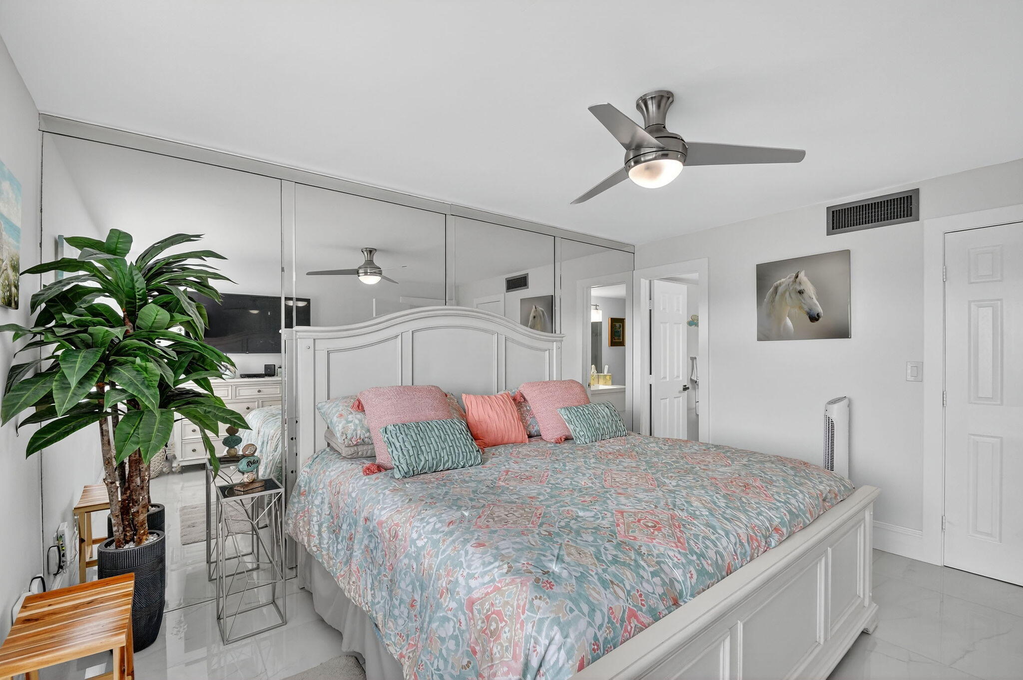 4381 Trevi Court, Unit 303 Lake Worth, FL 33467 - Photo 21 of 80 a bedroom with a large bed and a chandelier