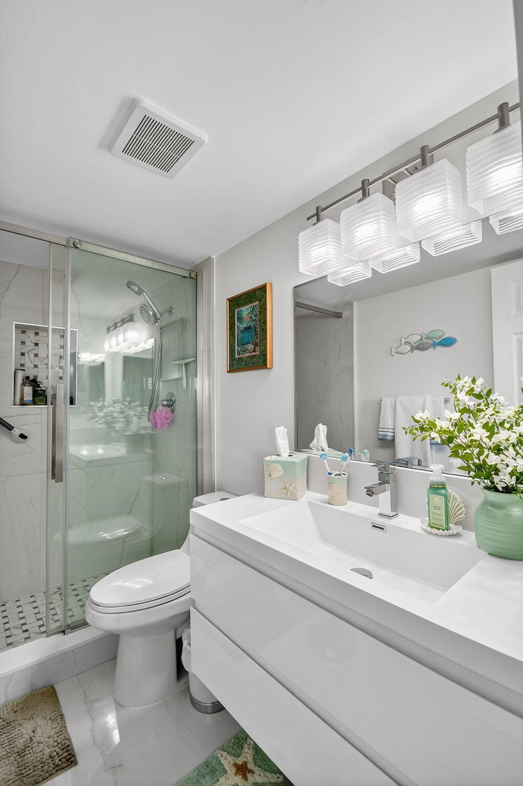 4381 Trevi Court, Unit 303 Lake Worth, FL 33467 - Photo 25 of 80 a bathroom with a sink a toilet and shower