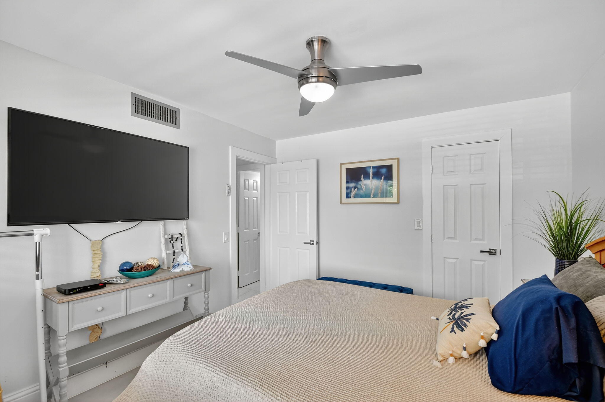 4381 Trevi Court, Unit 303 Lake Worth, FL 33467 - Photo 27 of 80 a bedroom with a bed and a flat screen tv