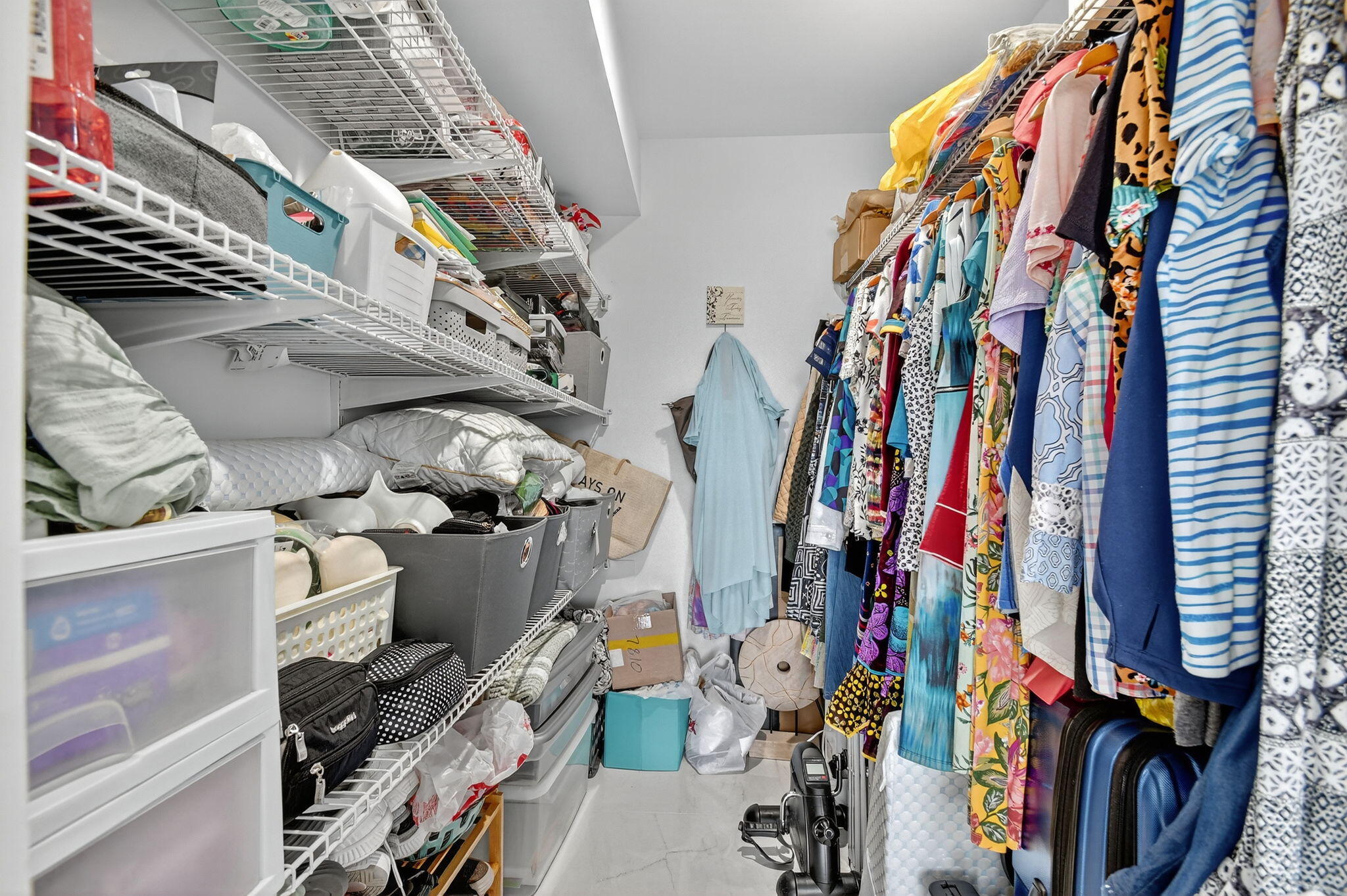 4381 Trevi Court, Unit 303 Lake Worth, FL 33467 - Photo 30 of 80 a view of walk in closet with clothes and shoes