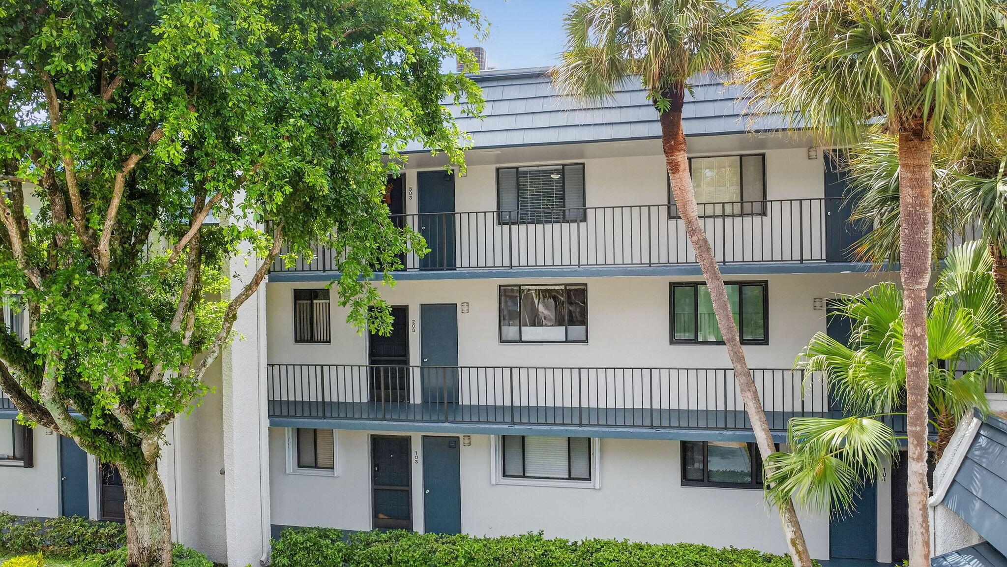 4381 Trevi Court, Unit 303 Lake Worth, FL 33467 - Photo 32 of 80 a front view of a house with a tree