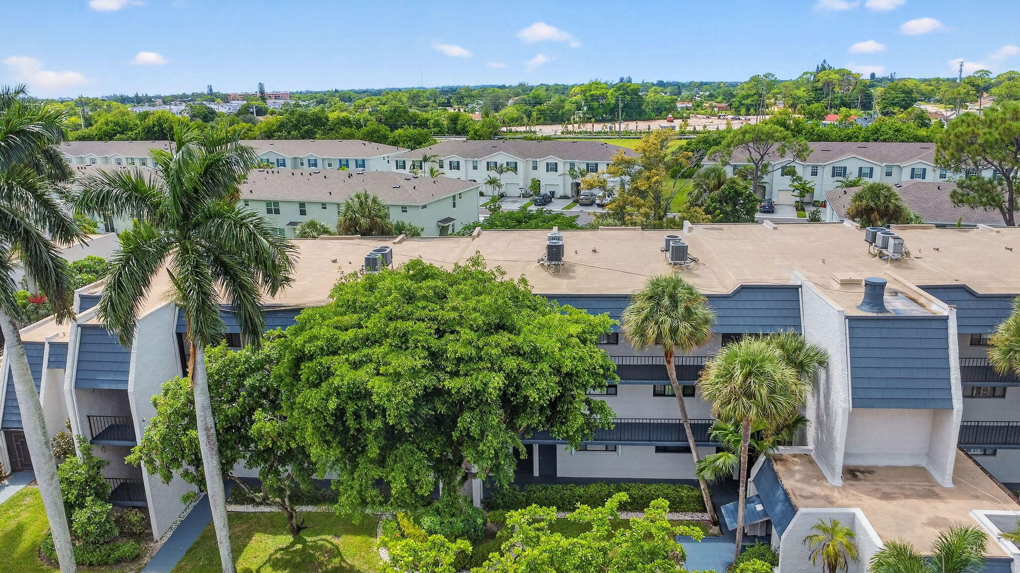 4381 Trevi Court, Unit 303 Lake Worth, FL 33467 - Photo 33 of 80 an aerial view of a house with a yard and lake view