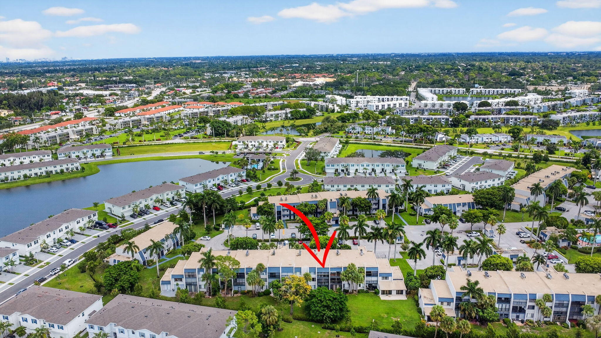 4381 Trevi Court, Unit 303 Lake Worth, FL 33467 - Photo 38 of 80 an aerial view of a city with lots of residential buildings ocean and mountain view in back