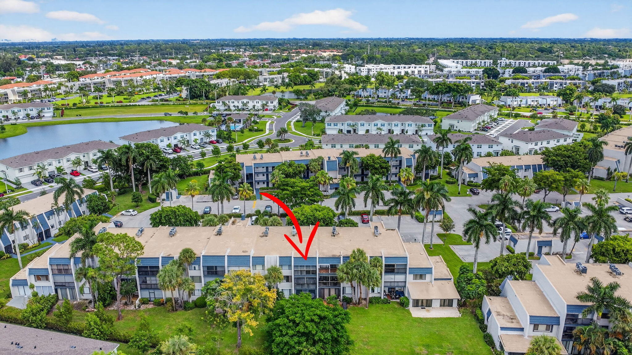 4381 Trevi Court, Unit 303 Lake Worth, FL 33467 - Photo 41 of 80 an aerial view of a city with lots of residential buildings ocean and mountain view in back