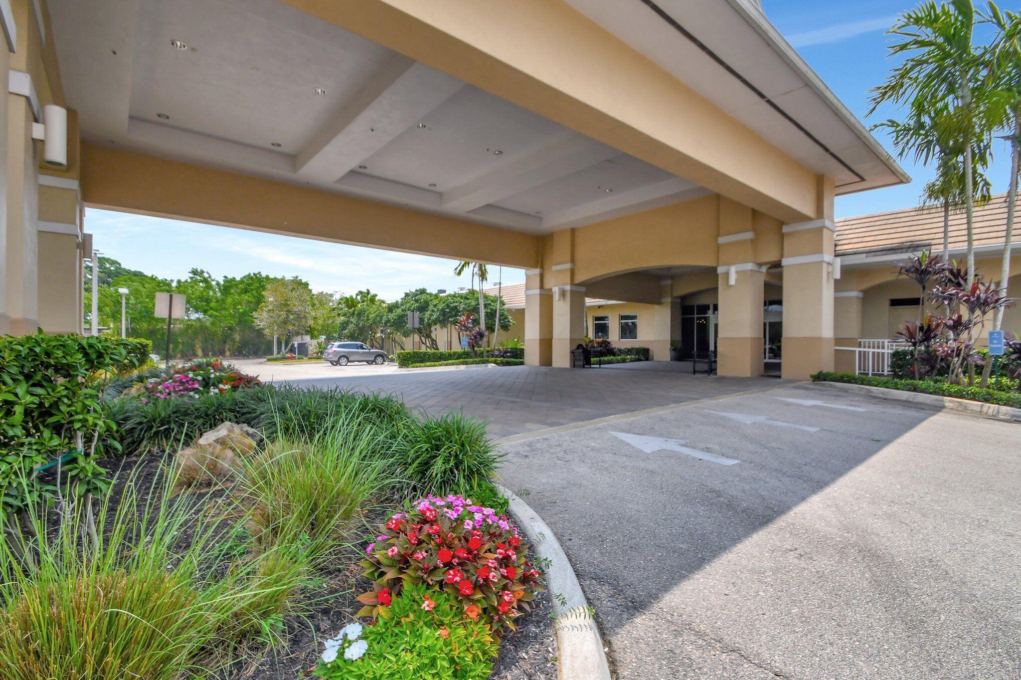 4381 Trevi Court, Unit 303 Lake Worth, FL 33467 - Photo 45 of 80 a view of a garden with plants and large trees