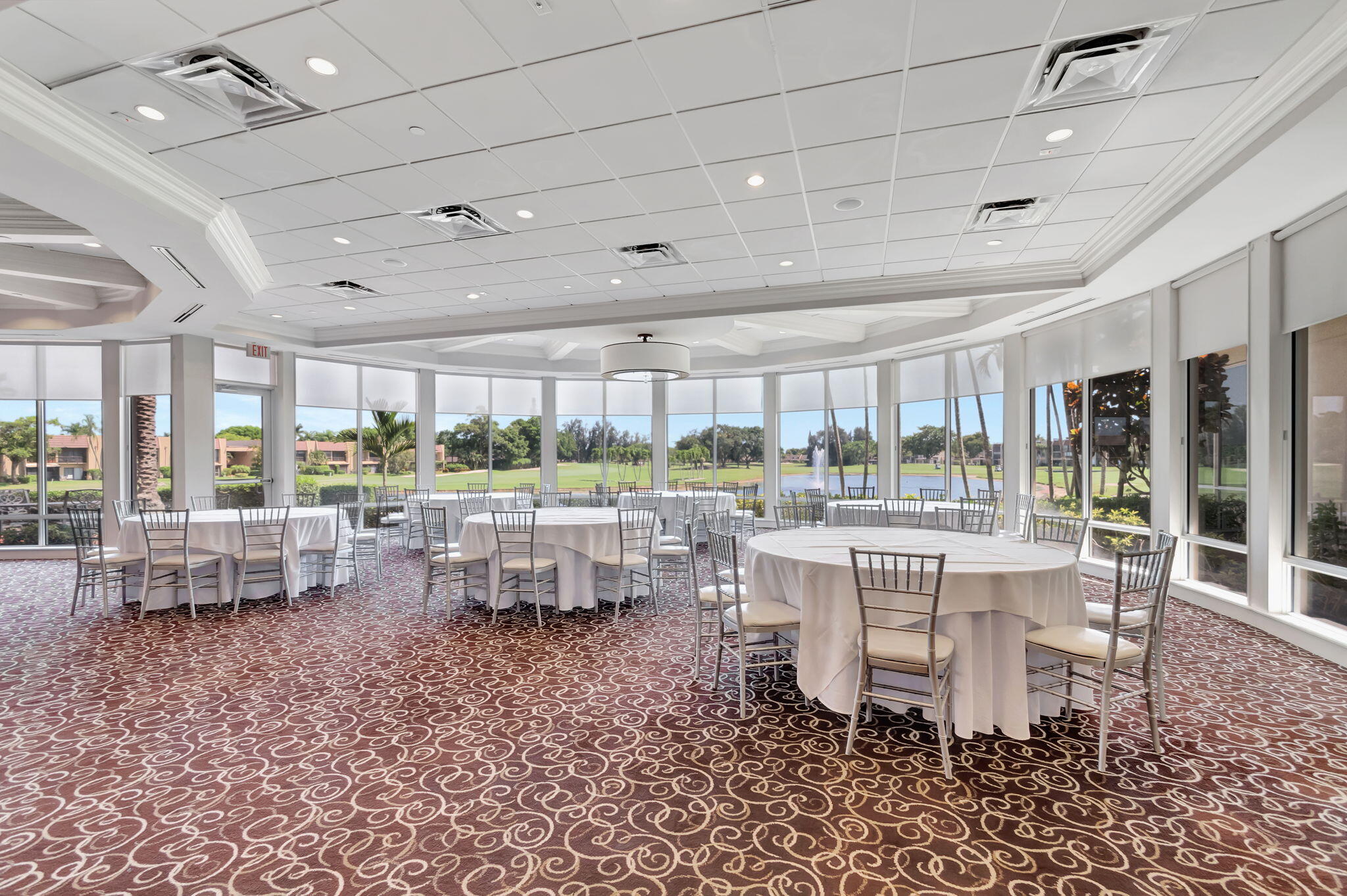 4381 Trevi Court, Unit 303 Lake Worth, FL 33467 - Photo 52 of 80 a room with lots of tables a large window and chairs