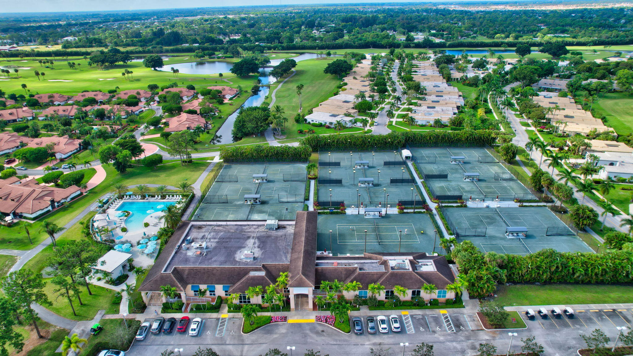 4381 Trevi Court, Unit 303 Lake Worth, FL 33467 - Photo 64 of 80 an aerial view of a city with lots of residential buildings and mountain view in back