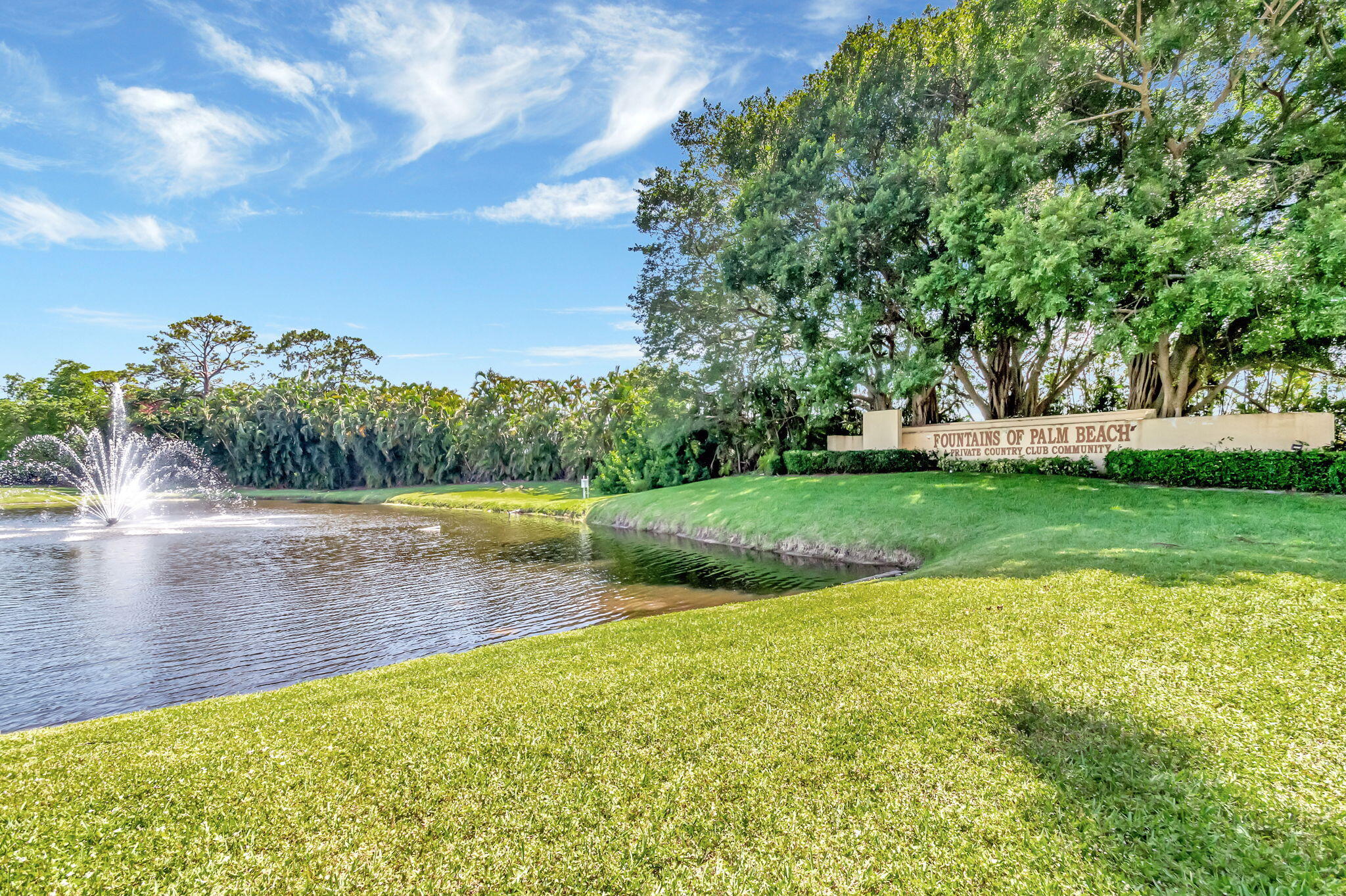 4381 Trevi Court, Unit 303 Lake Worth, FL 33467 - Photo 77 of 80 a view of a lake with houses in the background