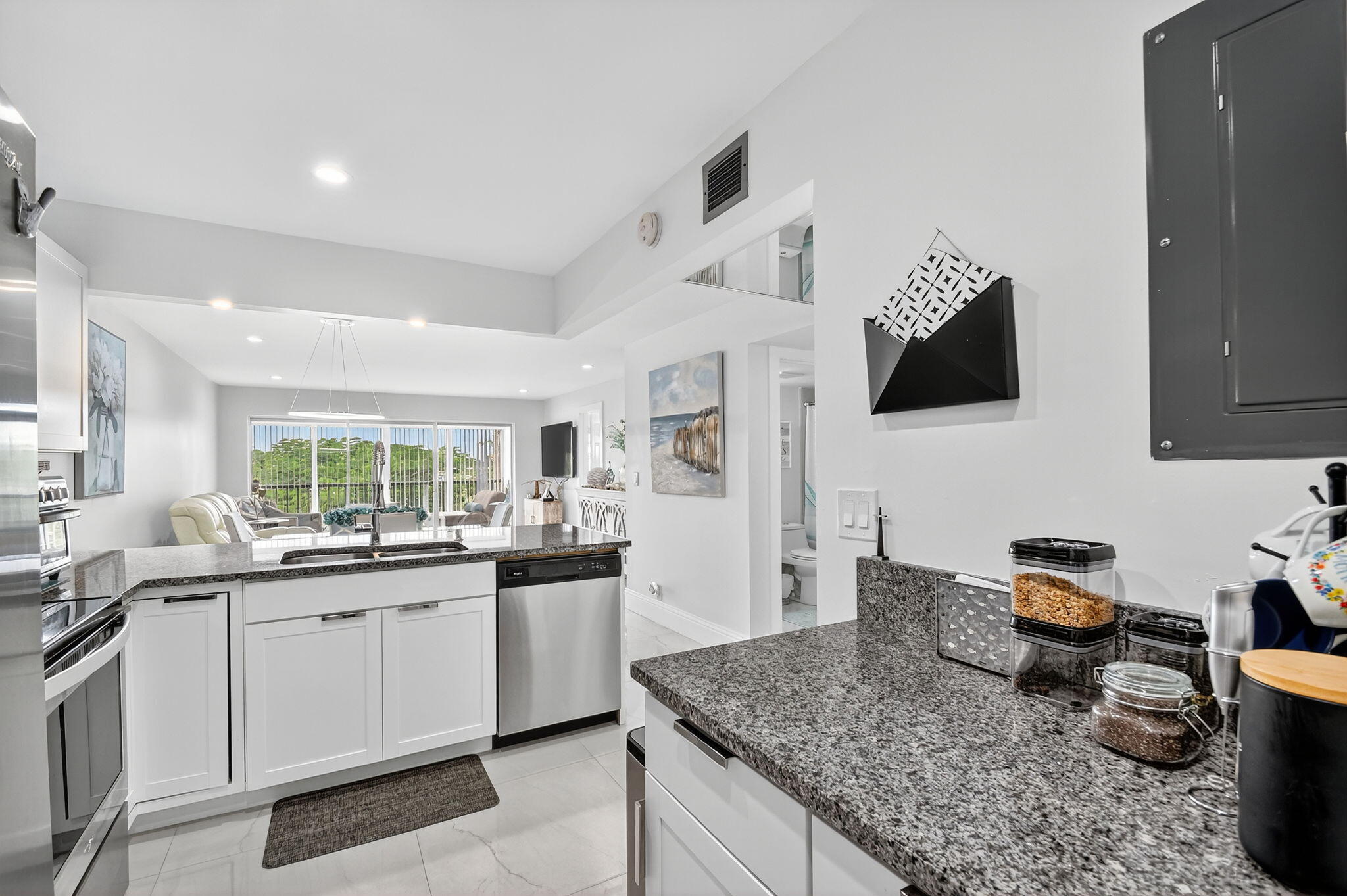 4381 Trevi Court, Unit 303 Lake Worth, FL 33467 - Photo 8 of 80 a kitchen with stainless steel appliances granite countertop a sink stove and cabinets