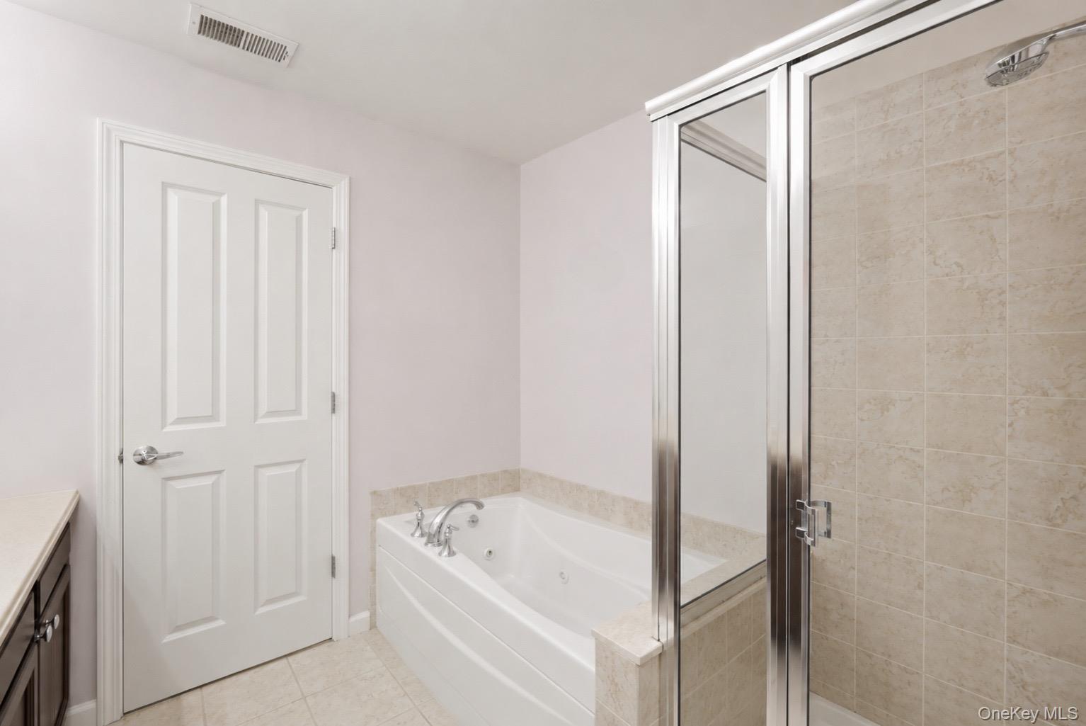 323 Waterside Close Peekskill, NY 10566 - Photo 18 of 42 Primary Bathroom featuring a built-in jetted tub, and a separate shower.