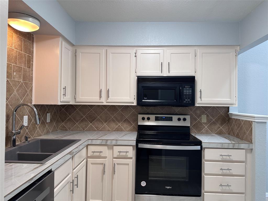 116 Main Place Euless, TX 76040 - Photo 14 of 31 a kitchen with granite countertop a stove and a sink