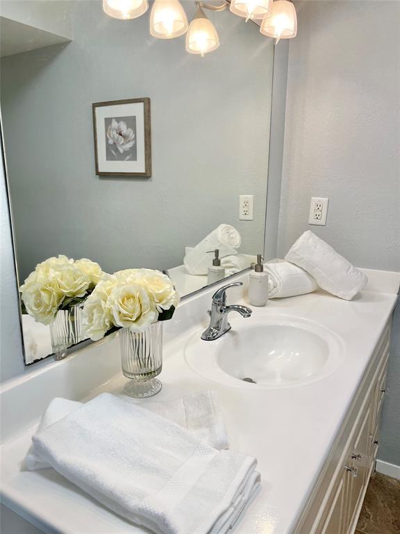 116 Main Place Euless, TX 76040 - Photo 16 of 31 a bedroom with a bed and a chandelier